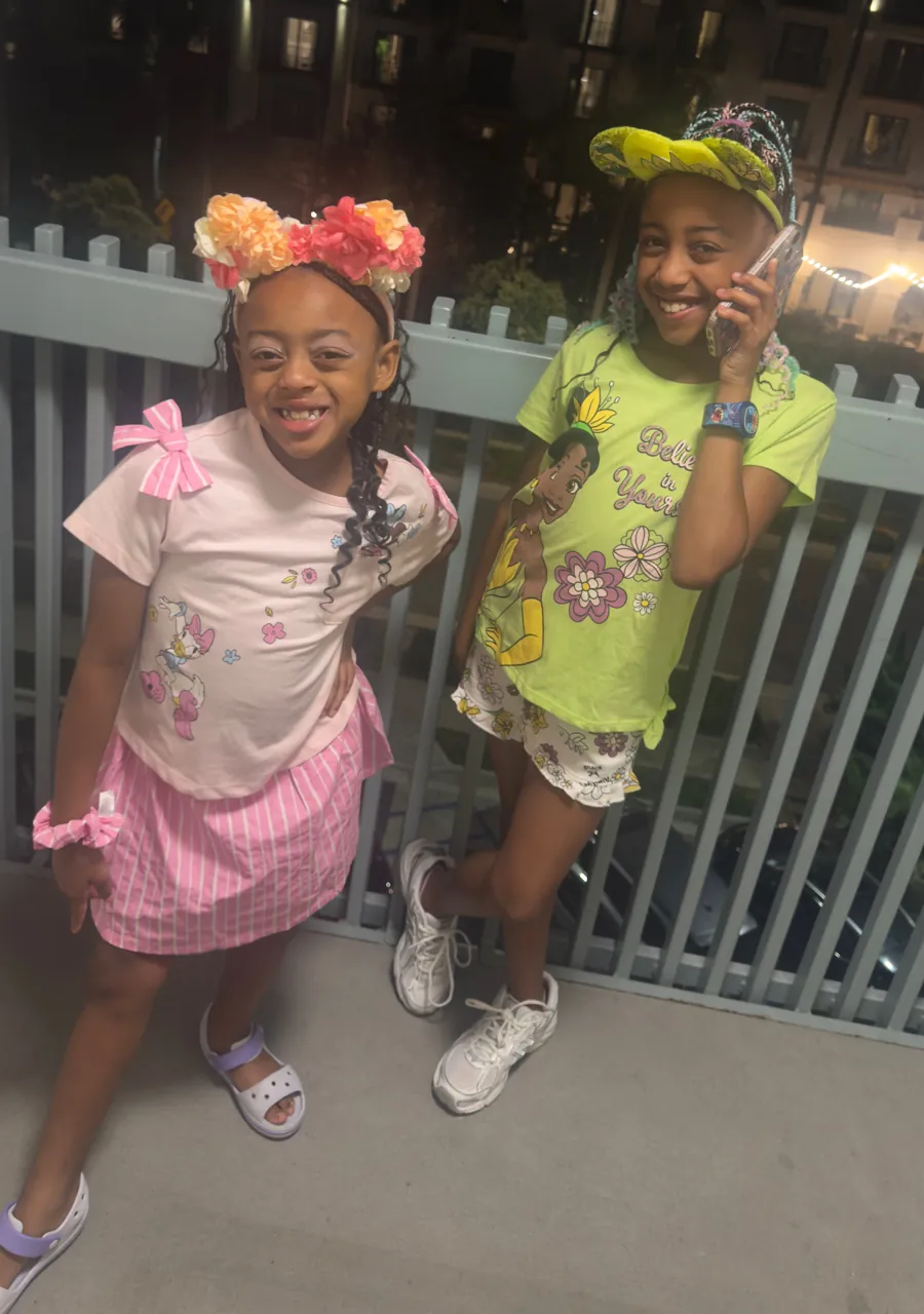 The sisters in flower headbands and a cap on an evening out